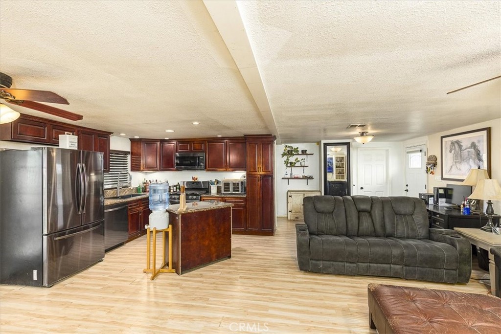44000 Sandstone Road Aguanga, CA 92536 - Photo 9 of 31 a living room with stainless steel appliances granite countertop a couch and cabinets