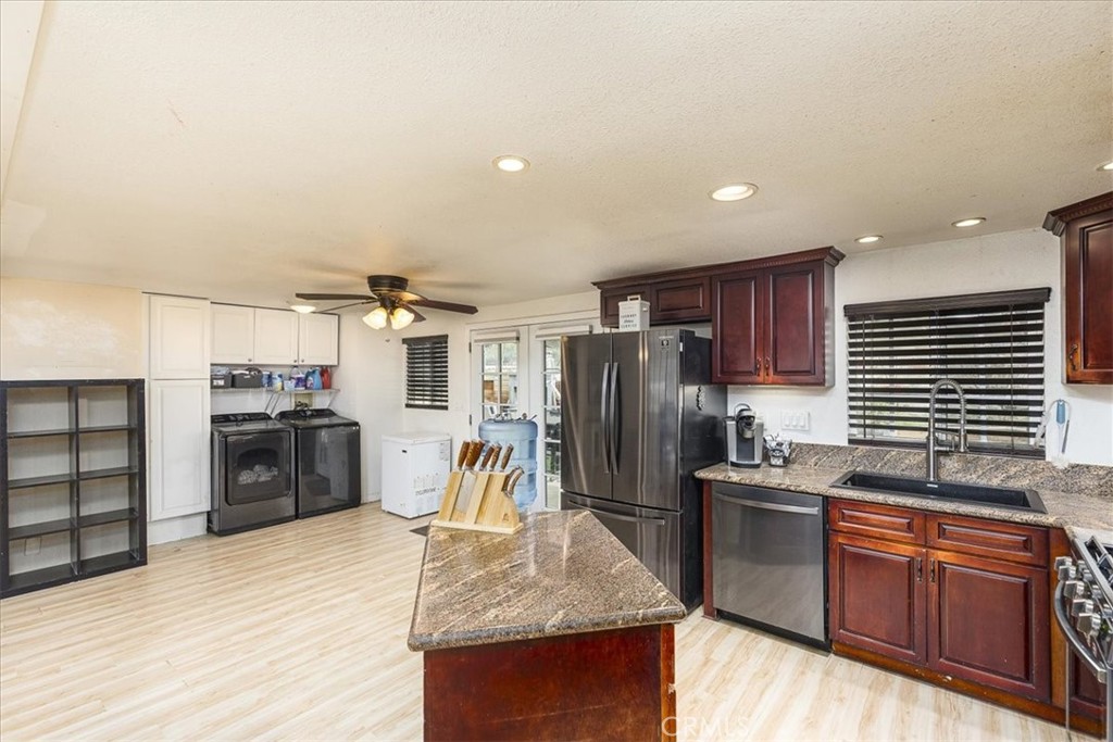 44000 Sandstone Road Aguanga, CA 92536 - Photo 10 of 31 a kitchen with stainless steel appliances granite countertop a sink dishwasher stove and refrigerator
