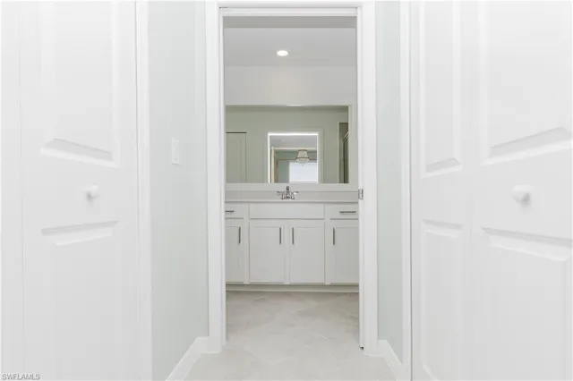 a living room with furniture kitchen and a chandelier