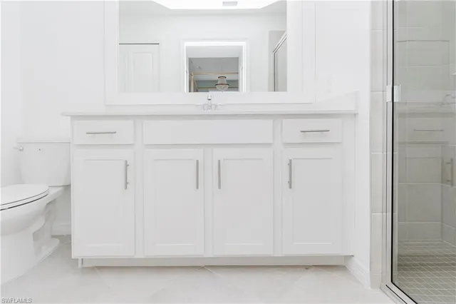 a dining hall with stainless steel appliances a dining table and chairs with wooden floor