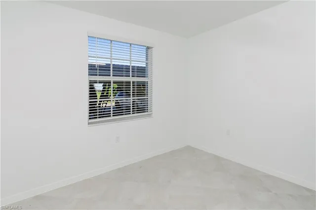 a view of a room with lots of wooden furniture and a kitchen