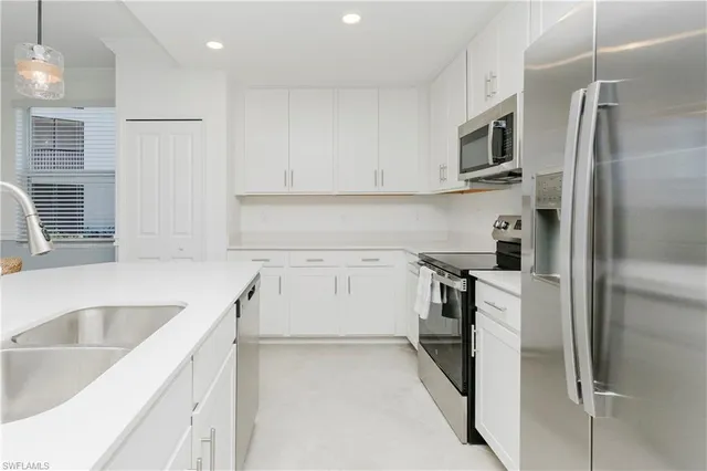 a bathroom with a sink a light fixture and a mirror
