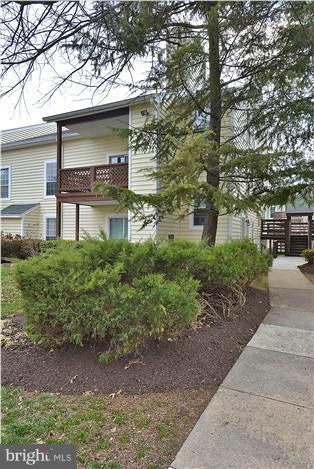 10031 Oakton Terrace Road, Unit 10031 Oakton, VA 22124 - Photo 1 of 19 a front view of a house with garden