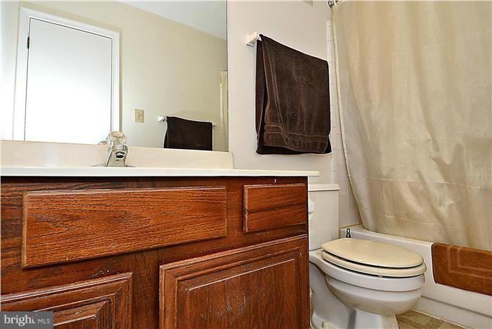 10031 Oakton Terrace Road, Unit 10031 Oakton, VA 22124 - Photo 14 of 19 a bathroom with a toilet a sink and mirror