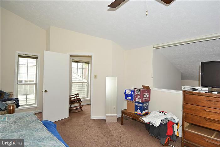 10031 Oakton Terrace Road, Unit 10031 Oakton, VA 22124 - Photo 17 of 19 a bedroom with furniture and a window