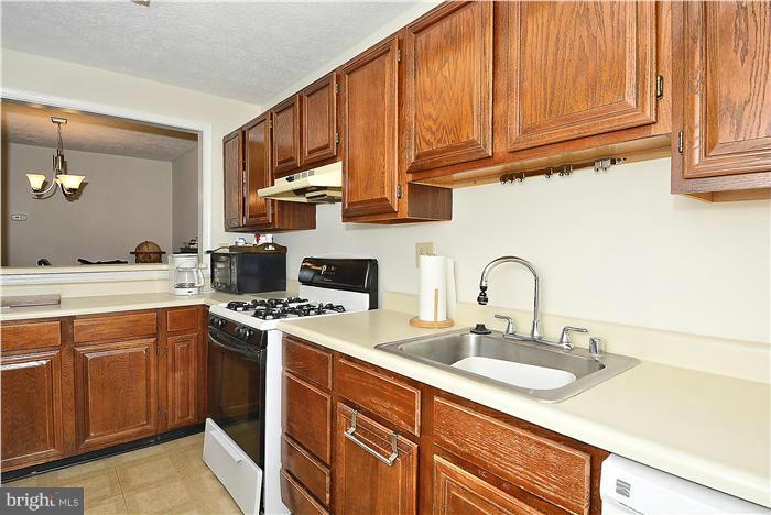 10031 Oakton Terrace Road, Unit 10031 Oakton, VA 22124 - Photo 4 of 19 a kitchen with stainless steel appliances granite countertop a sink stove and cabinets