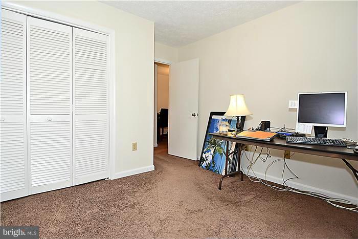 10031 Oakton Terrace Road, Unit 10031 Oakton, VA 22124 - Photo 7 of 19 a view of a workspace with furniture and a window