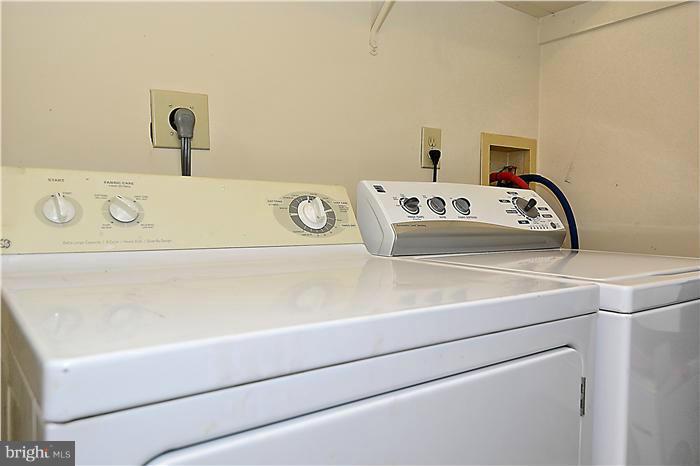 10031 Oakton Terrace Road, Unit 10031 Oakton, VA 22124 - Photo 9 of 19 a utility room with a sink and a washer dryer