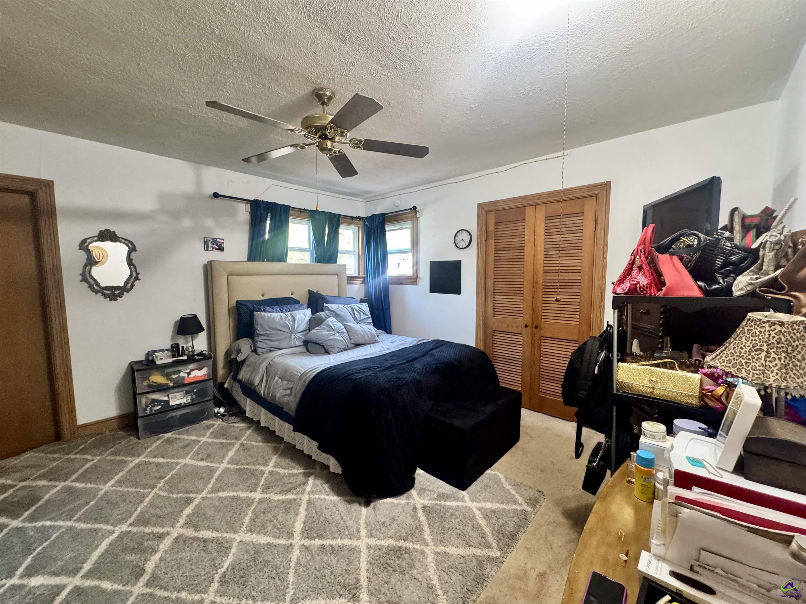 914 Adderton Street Americus, GA 31719 - Photo 21 of 53 a bedroom with a bed and a walk in closet