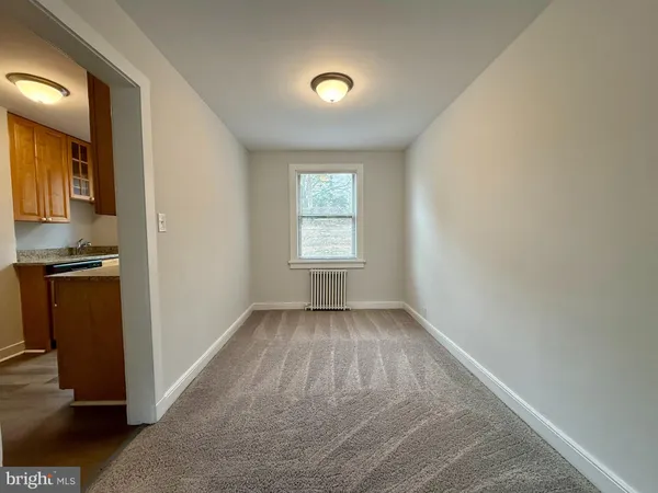 an empty room with closet and windows