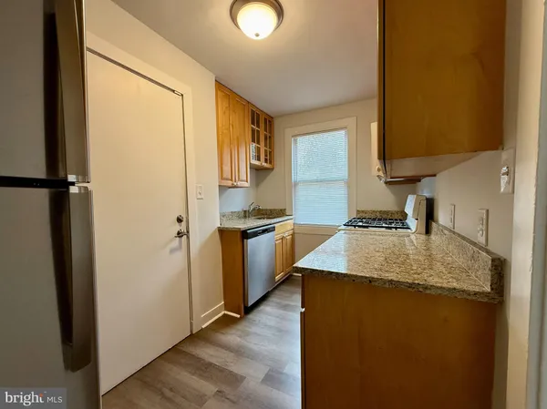 a kitchen with a sink appliances and cabinets