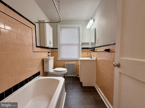 a bathroom with a sink a toilet and tub