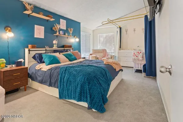 a bedroom with a bed and window