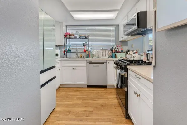 a kitchen with stainless steel appliances granite countertop a sink and cabinets