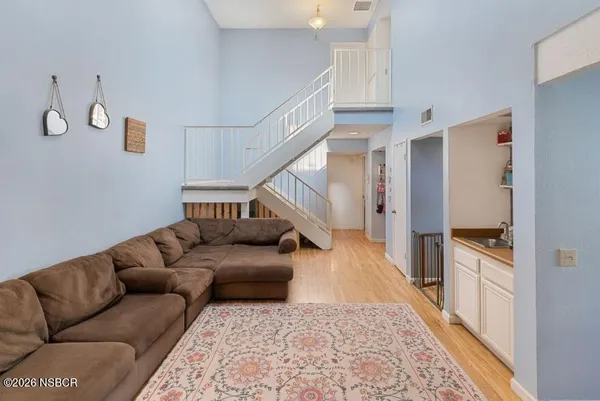 a living room with furniture and stairs