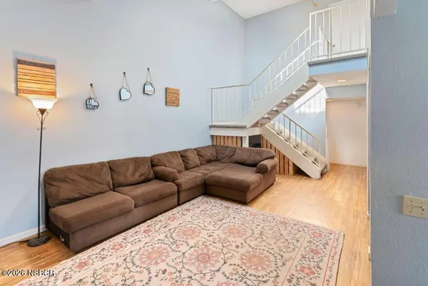 a living room with furniture and stairs