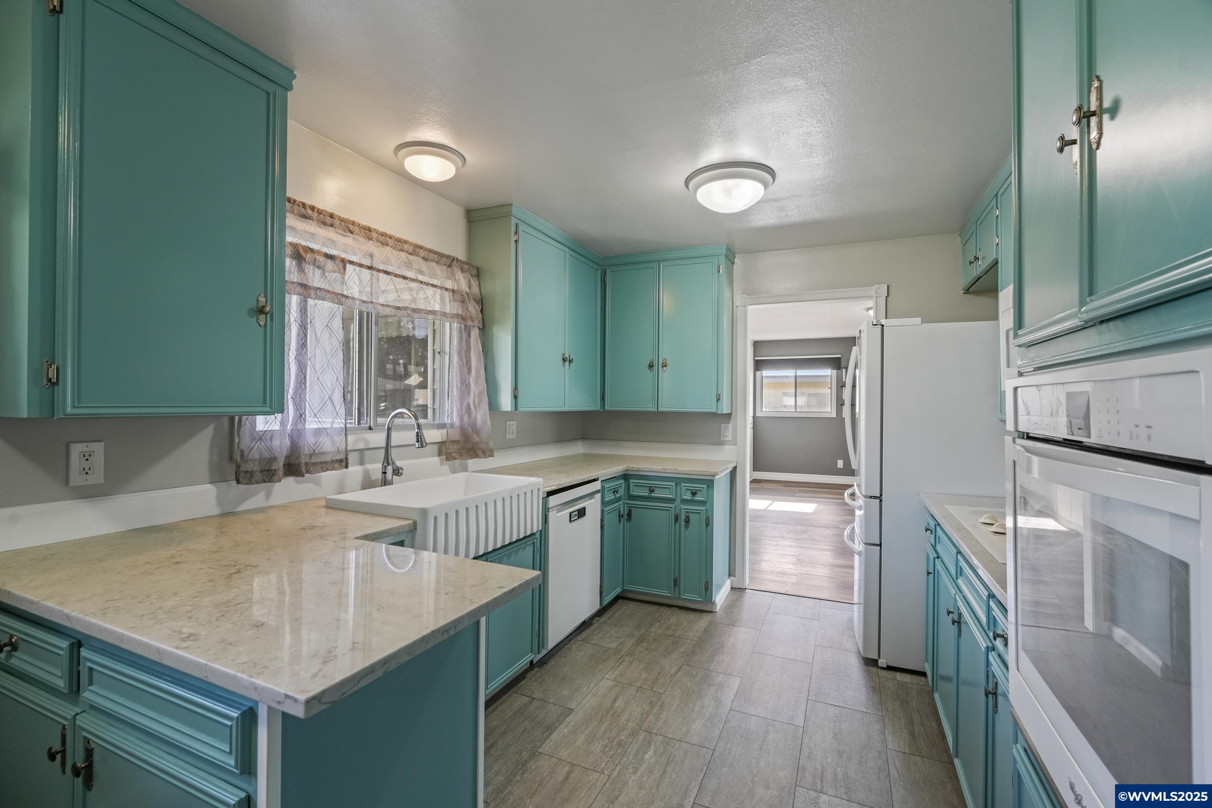 1023 37th Avenue Southwest Albany, OR 97321 - Photo 15 of 47 a kitchen with a sink stove and refrigerator