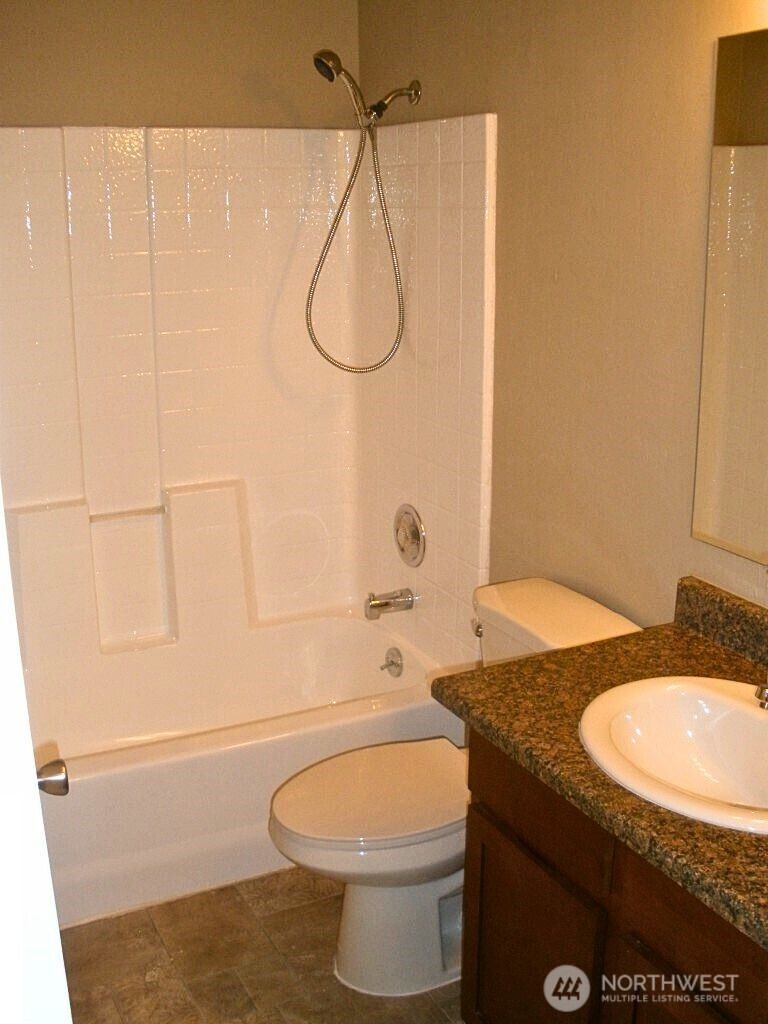 18332 Hurst Road Lynnwood, WA 98037 - Photo 9 of 9 a bathroom with a granite countertop sink toilet and shower