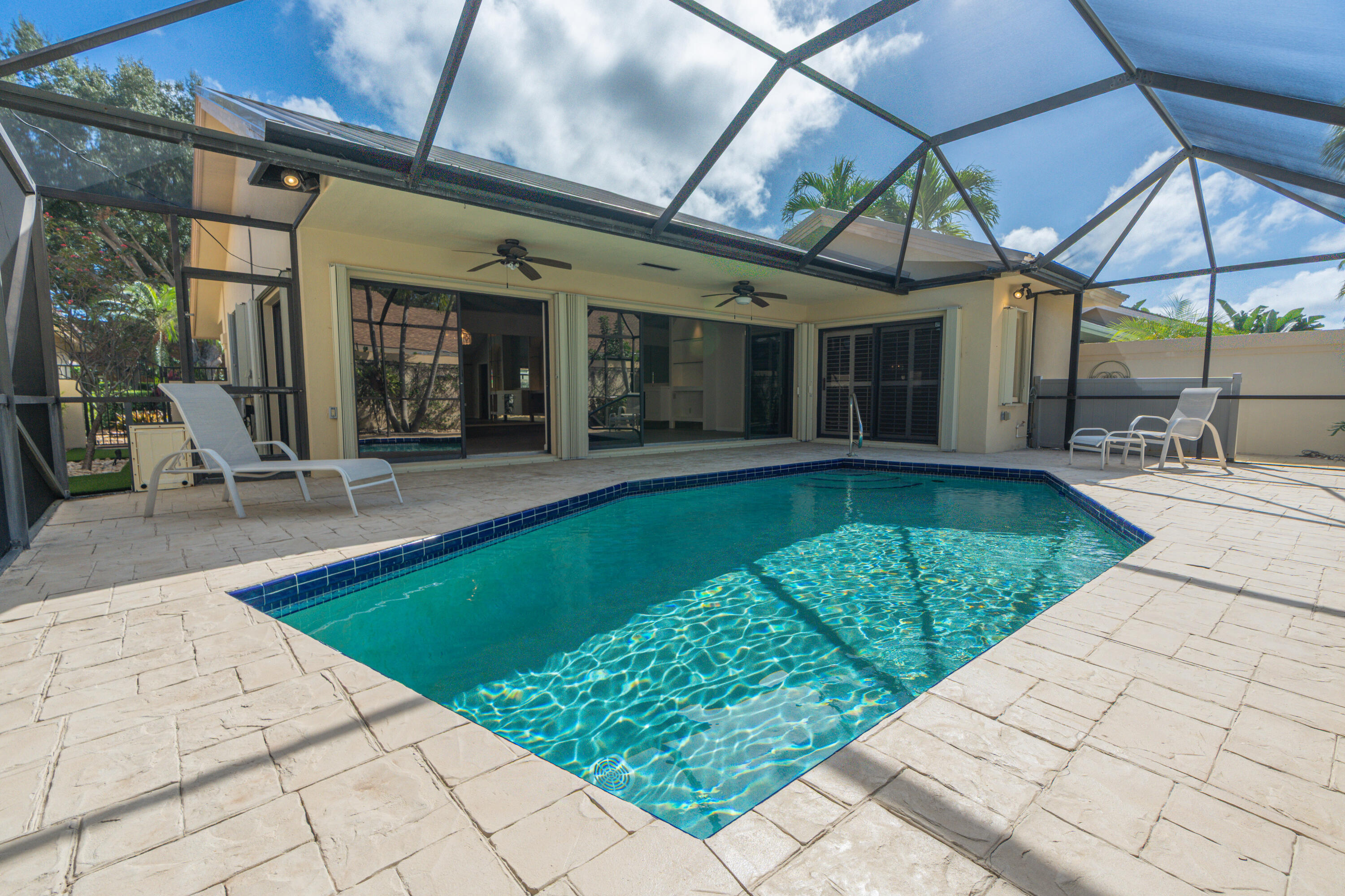 422 River Edge Road Jupiter, FL 33477 - Photo 11 of 39 a view of a patio with a table and chairs under an umbrella