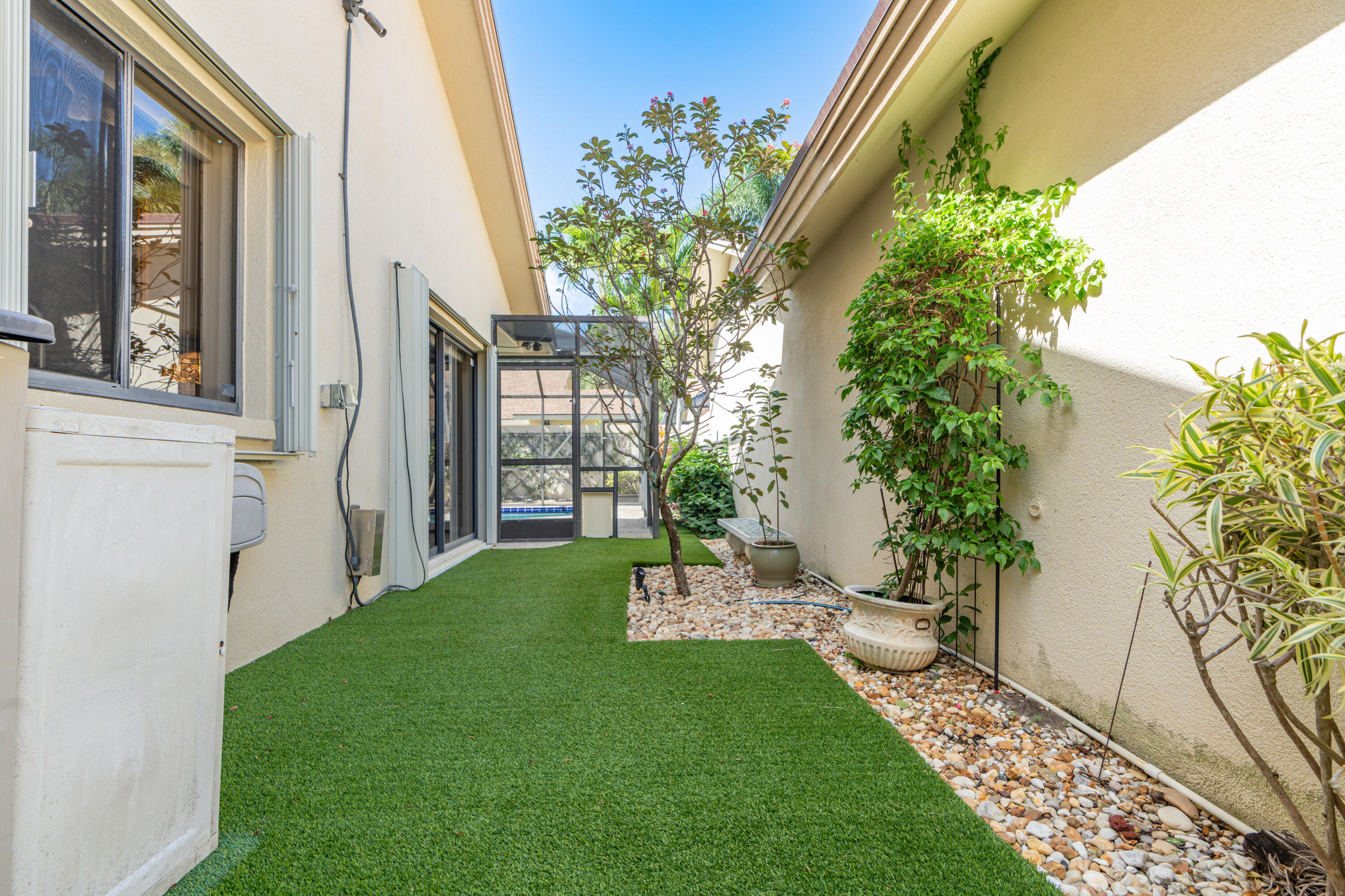 422 River Edge Road Jupiter, FL 33477 - Photo 14 of 39 a view of an entrance to house with yard