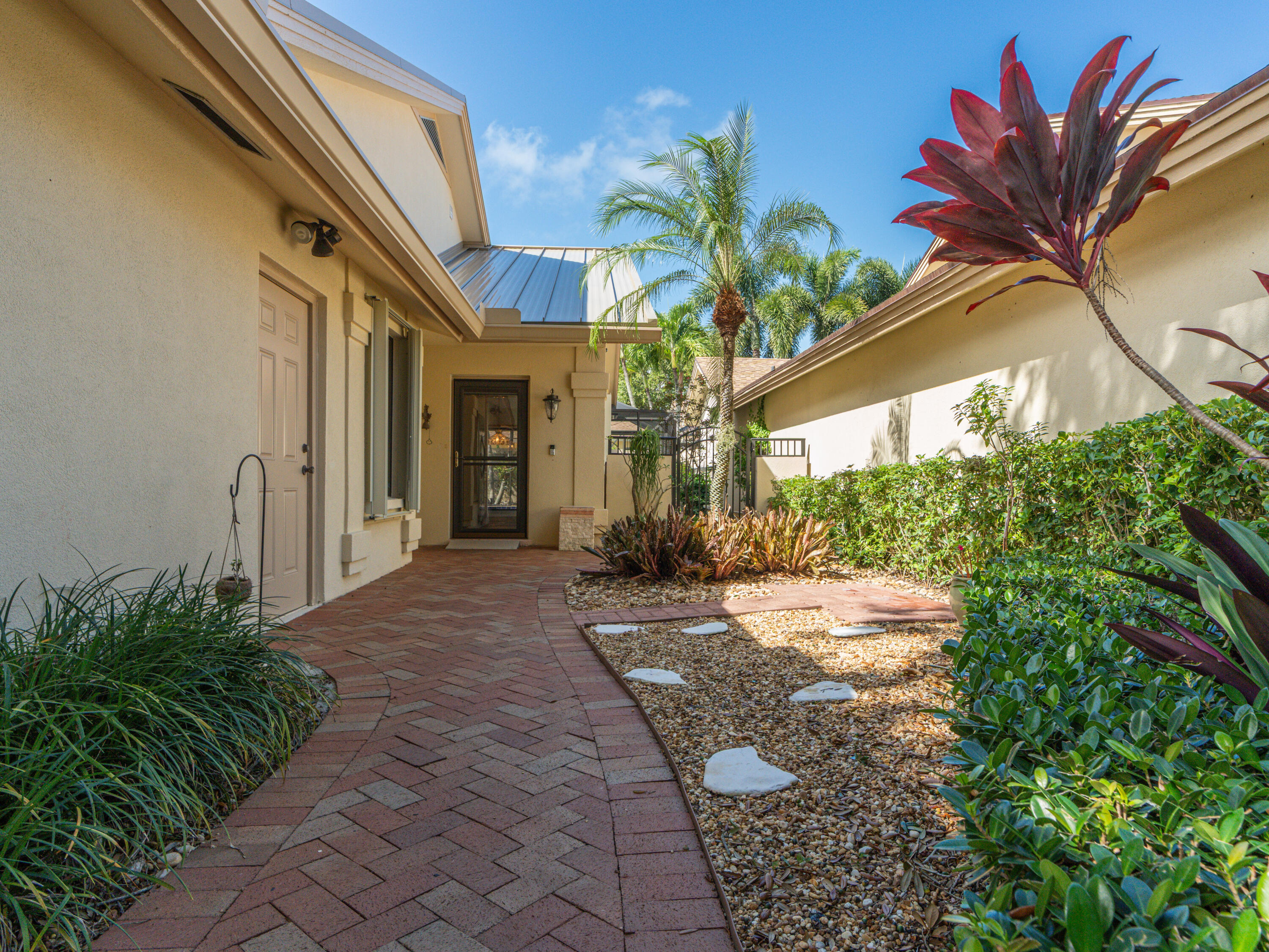 422 River Edge Road Jupiter, FL 33477 - Photo 15 of 39 a house with palm tree in front of it