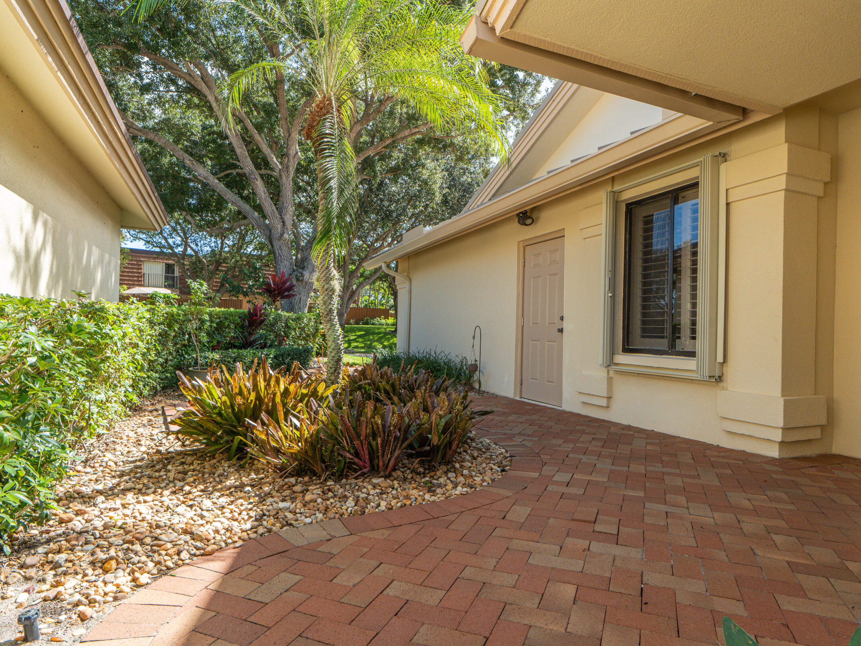 422 River Edge Road Jupiter, FL 33477 - Photo 16 of 39 a front view of a house with garden