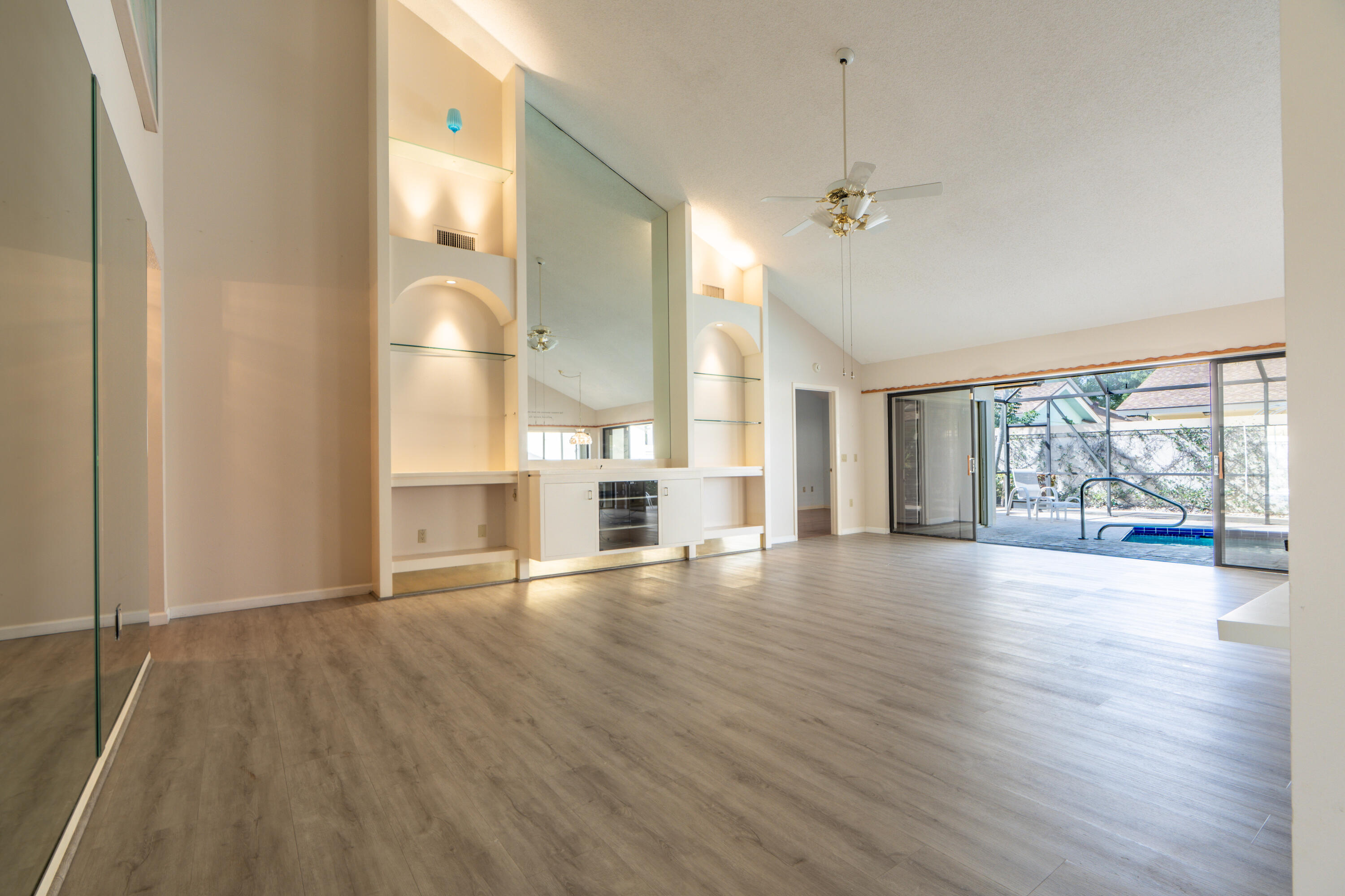 422 River Edge Road Jupiter, FL 33477 - Photo 18 of 39 a view of empty room with wooden floor and fan