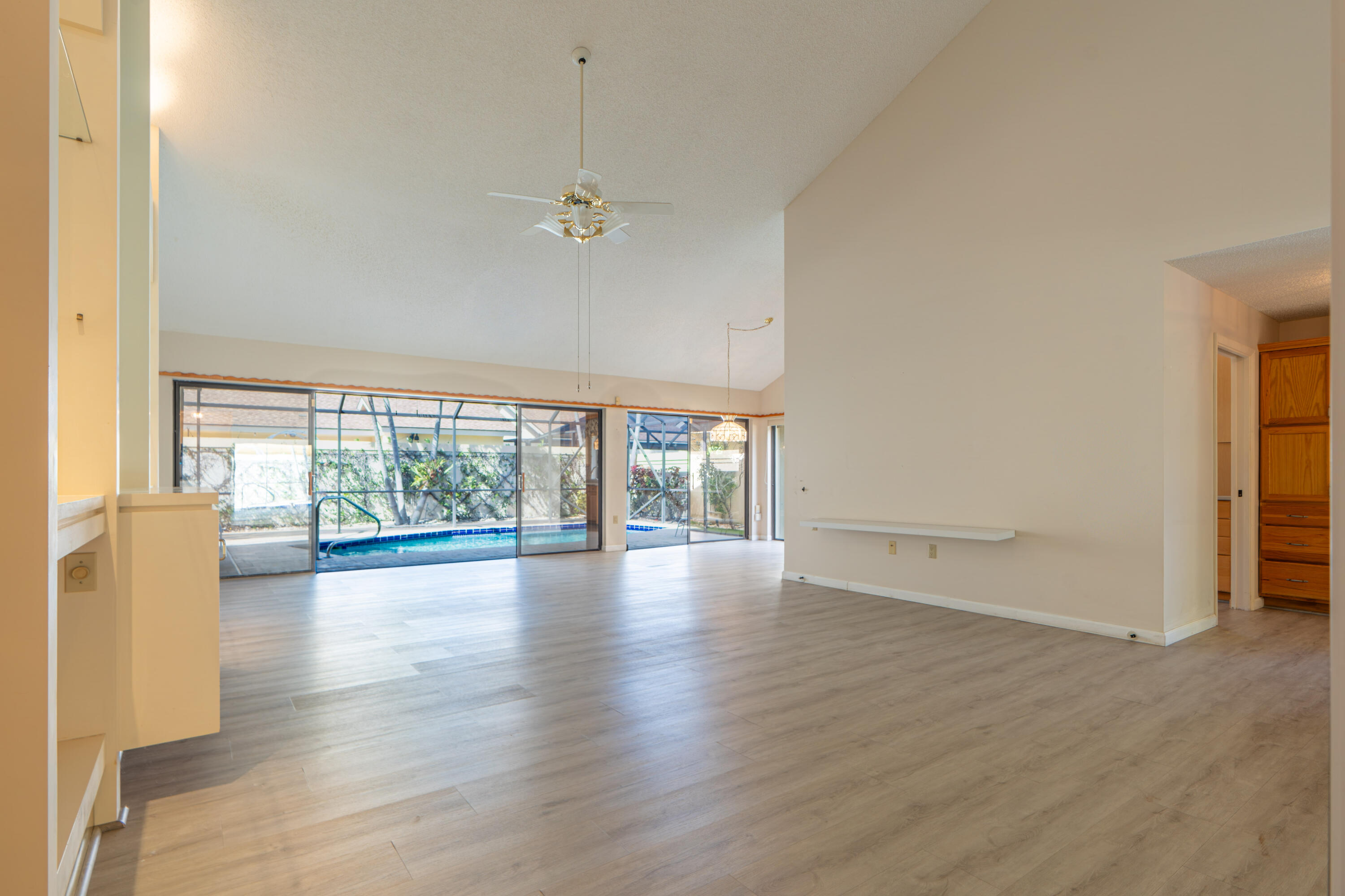 422 River Edge Road Jupiter, FL 33477 - Photo 19 of 39 a view of empty room with wooden floor and fan