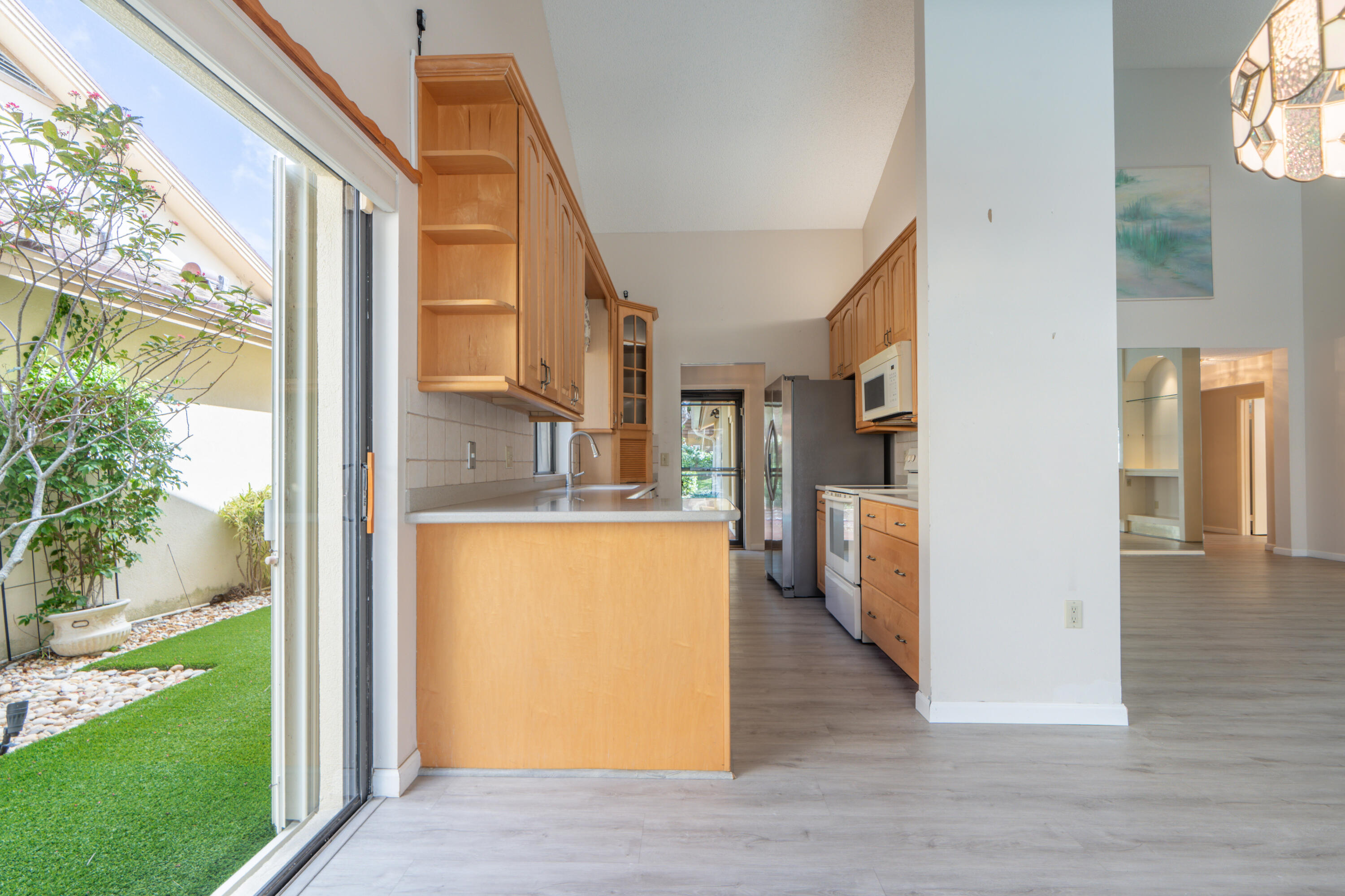 422 River Edge Road Jupiter, FL 33477 - Photo 22 of 39 a view of a kitchen from the hallway