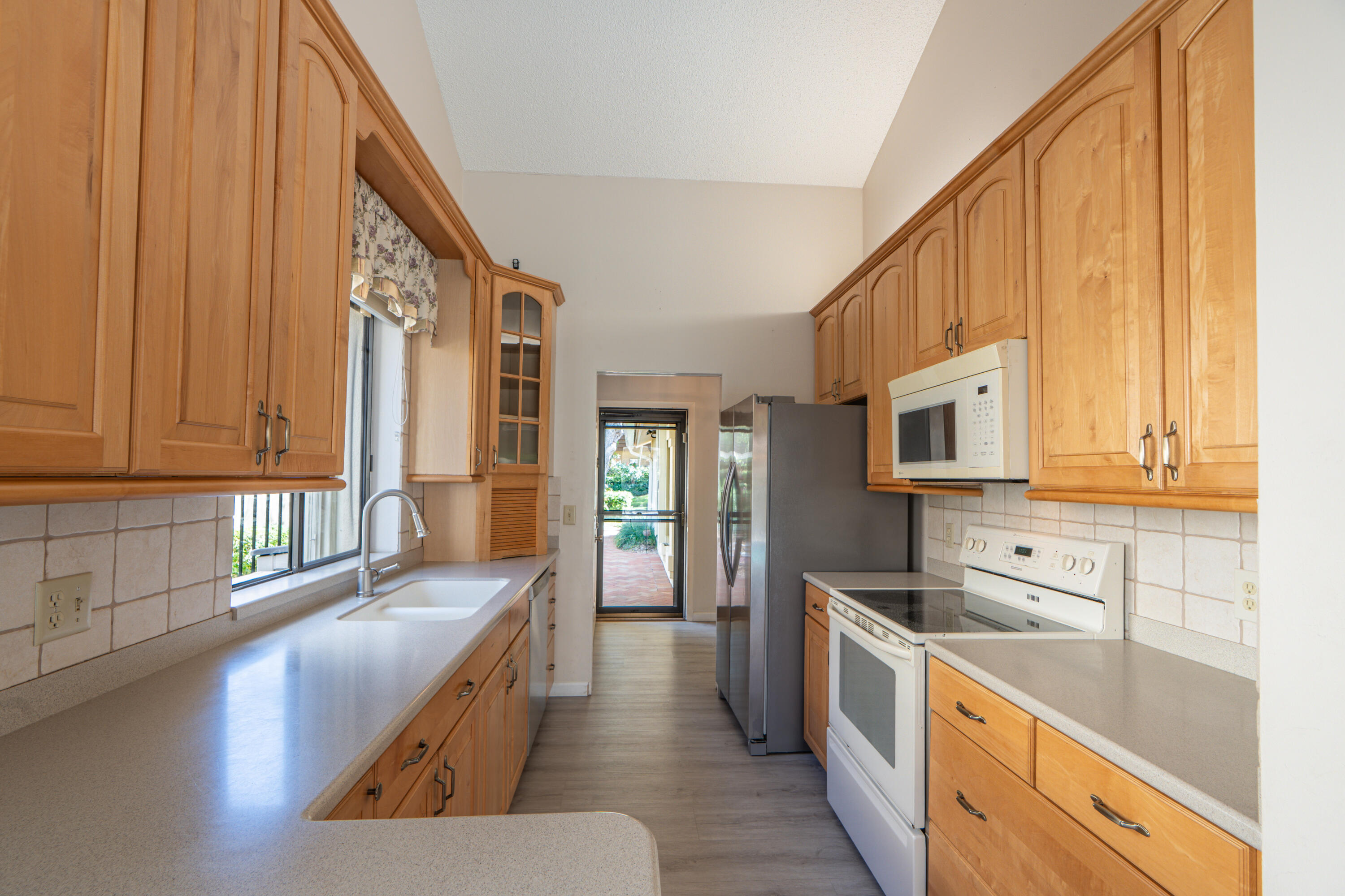 422 River Edge Road Jupiter, FL 33477 - Photo 24 of 39 a large kitchen with stainless steel appliances granite countertop a lot of counter space and a sink