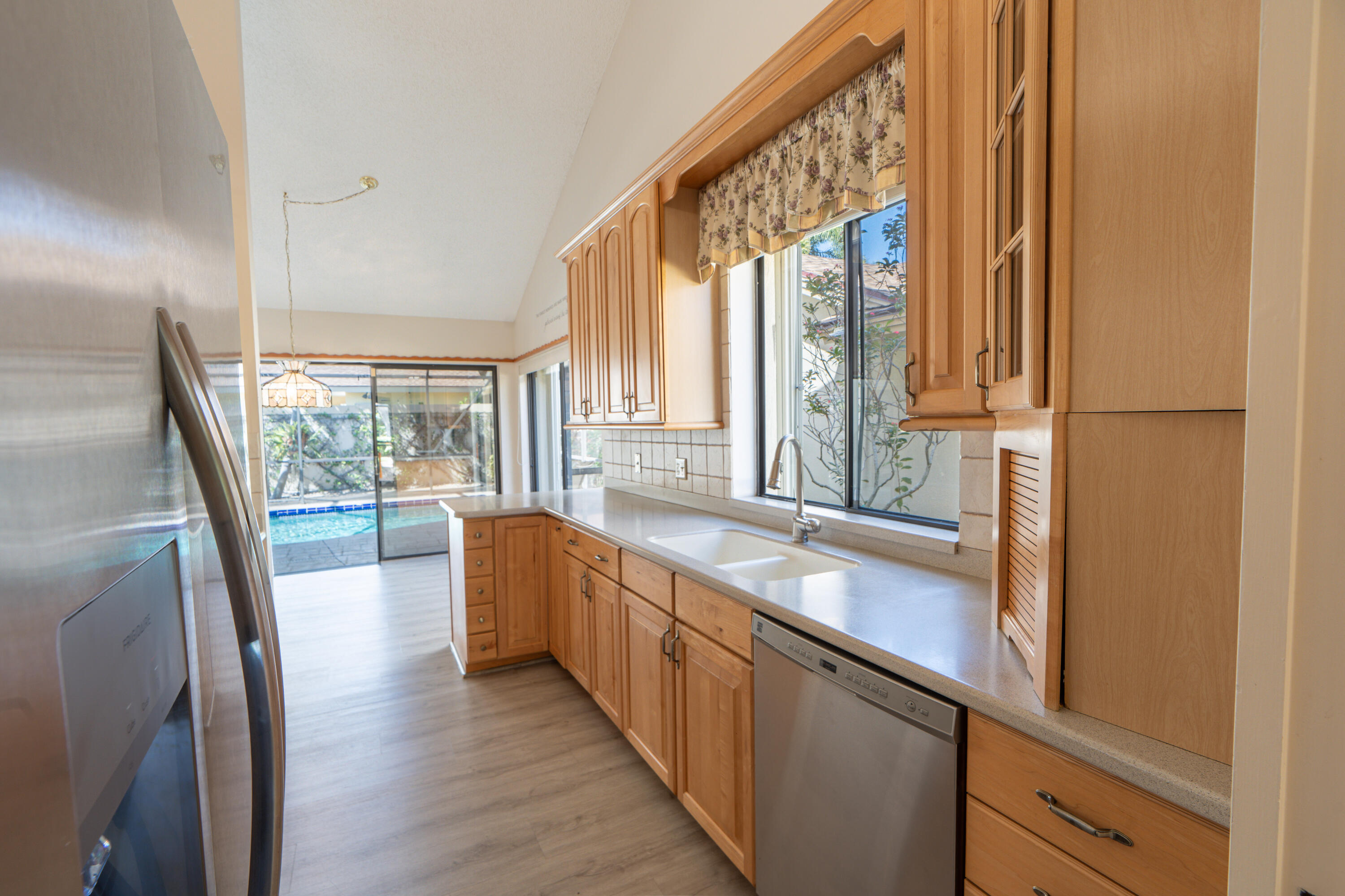 422 River Edge Road Jupiter, FL 33477 - Photo 25 of 39 a large white kitchen with a large window