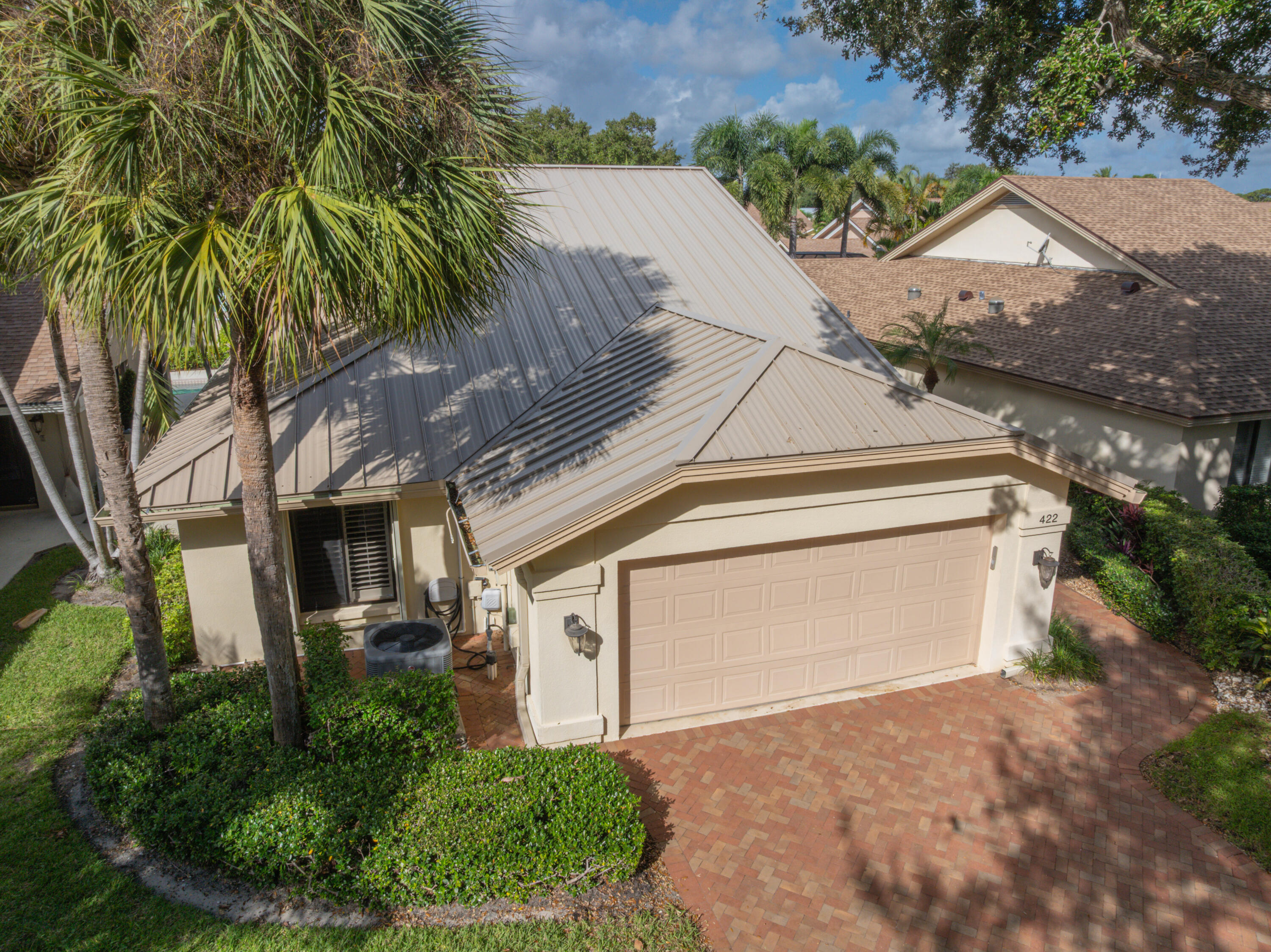422 River Edge Road Jupiter, FL 33477 - Photo 3 of 39 a front view of a house with garden