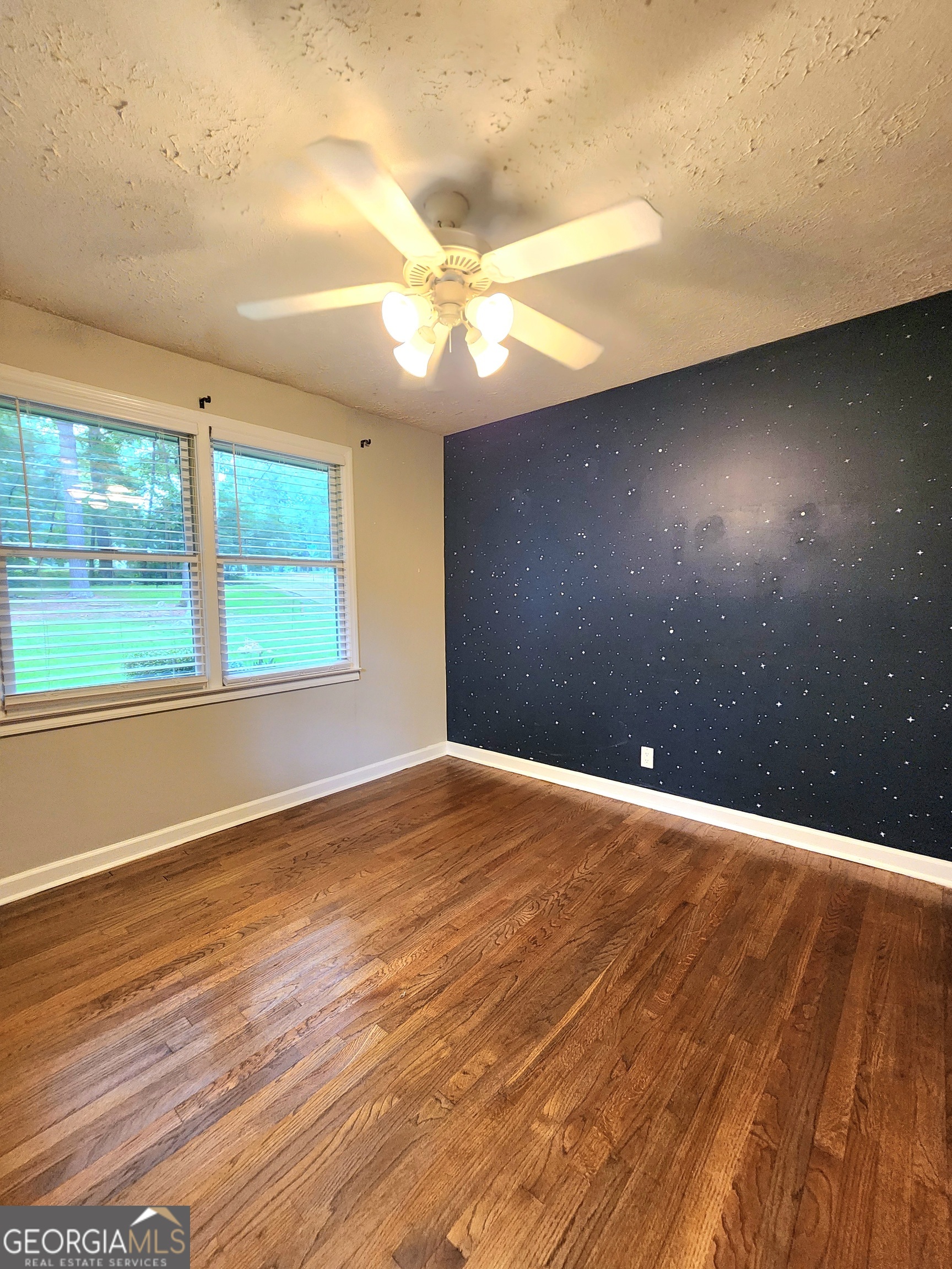 807 Wera Place Macon, GA 31210 - Photo 14 of 46 a view of an empty room with wooden floor and a window