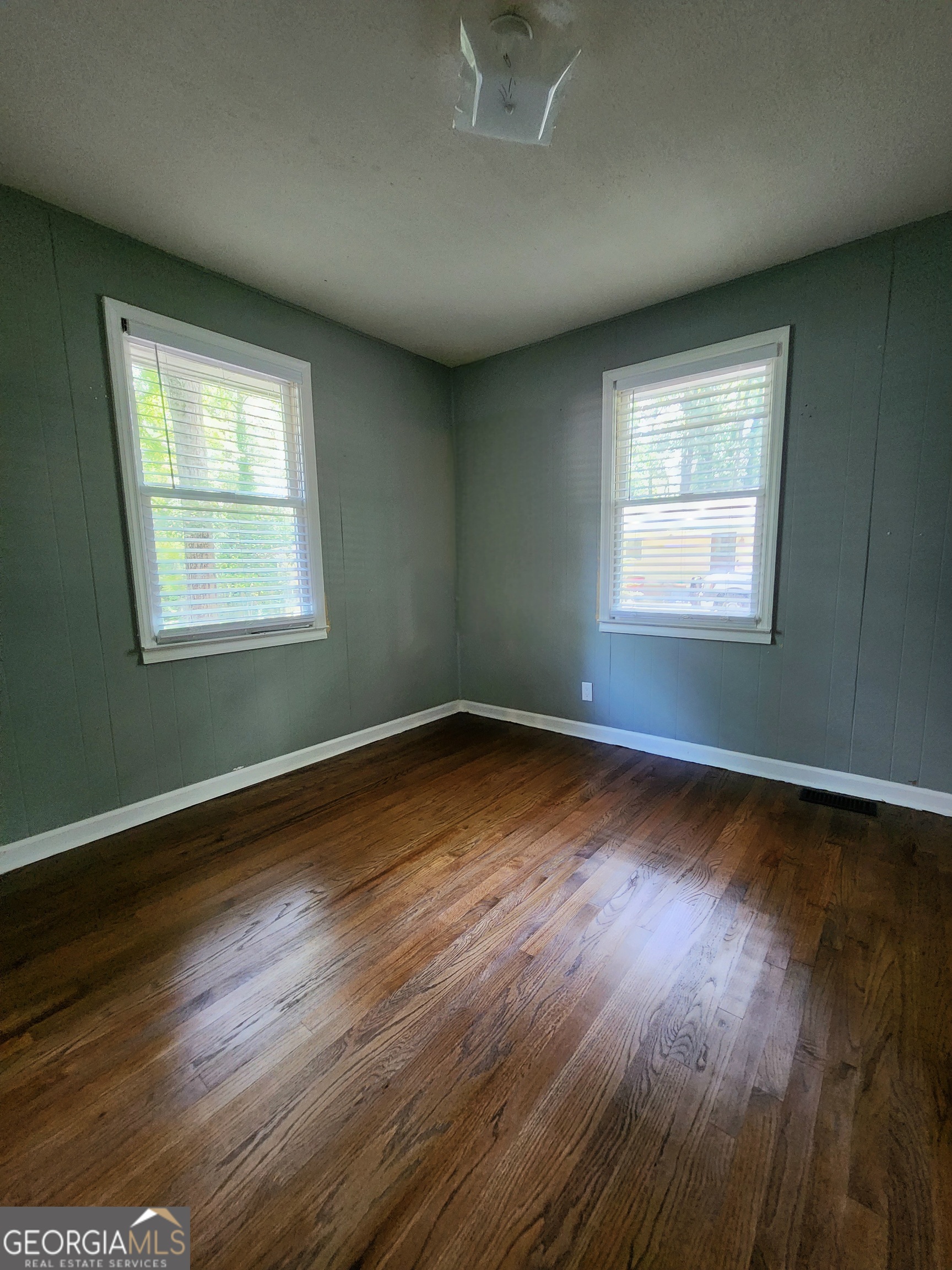 807 Wera Place Macon, GA 31210 - Photo 15 of 46 an empty room with wooden floor and windows