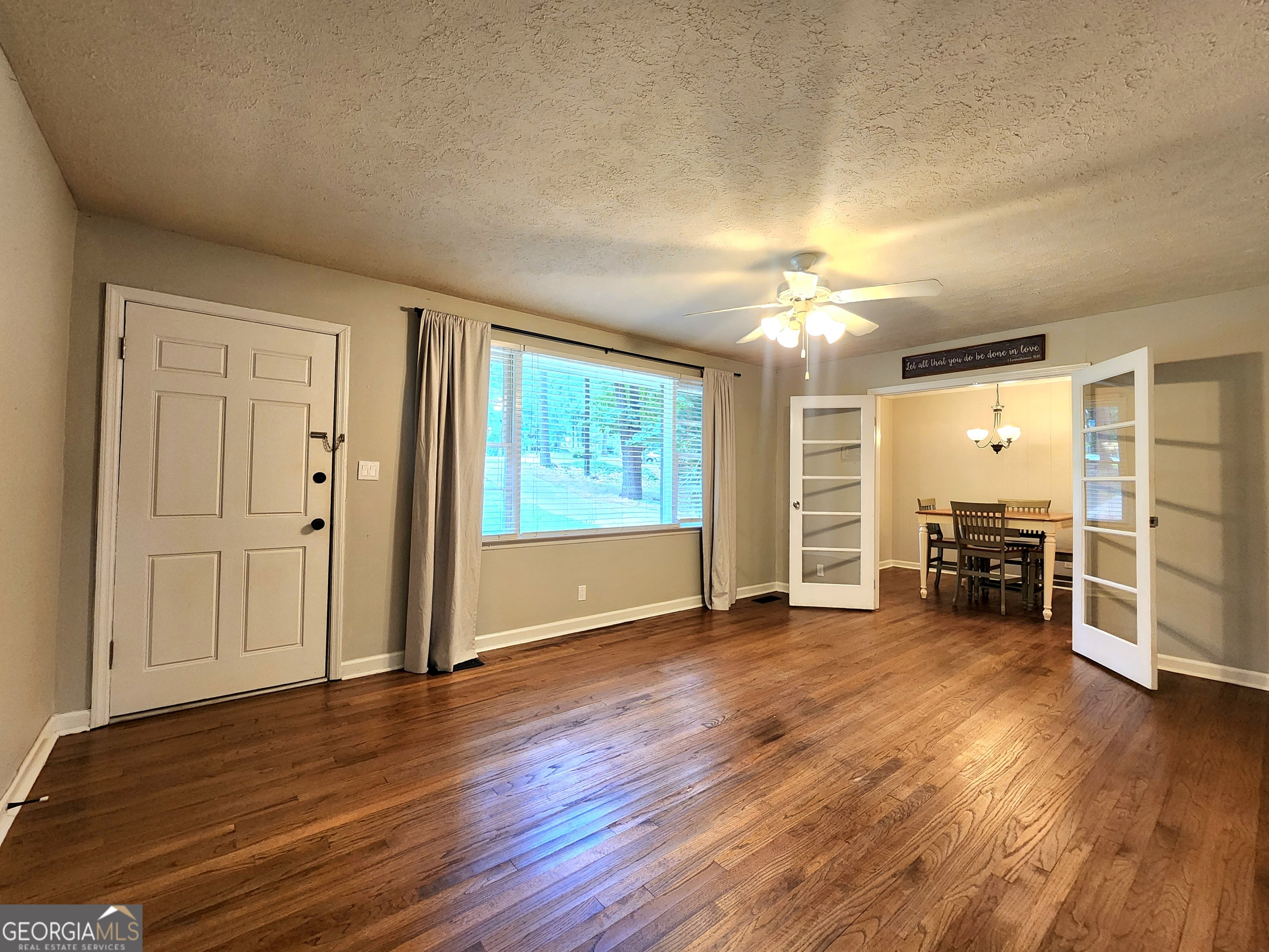 807 Wera Place Macon, GA 31210 - Photo 17 of 46 an empty room with wooden floor chandelier and windows