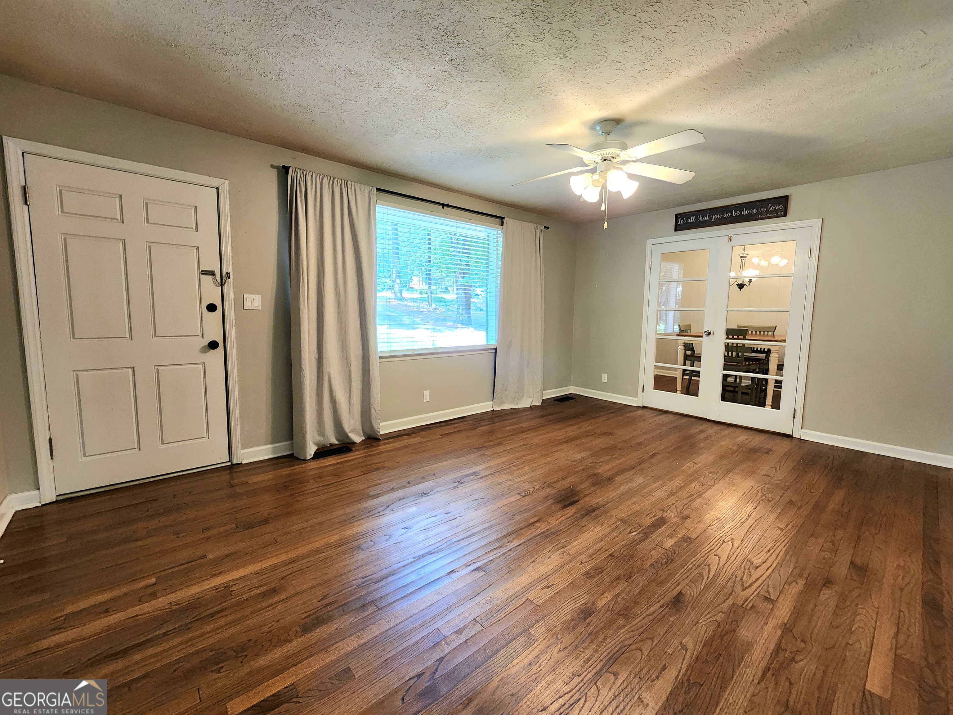 807 Wera Place Macon, GA 31210 - Photo 24 of 46 an empty room with wooden floor chandelier fan and windows