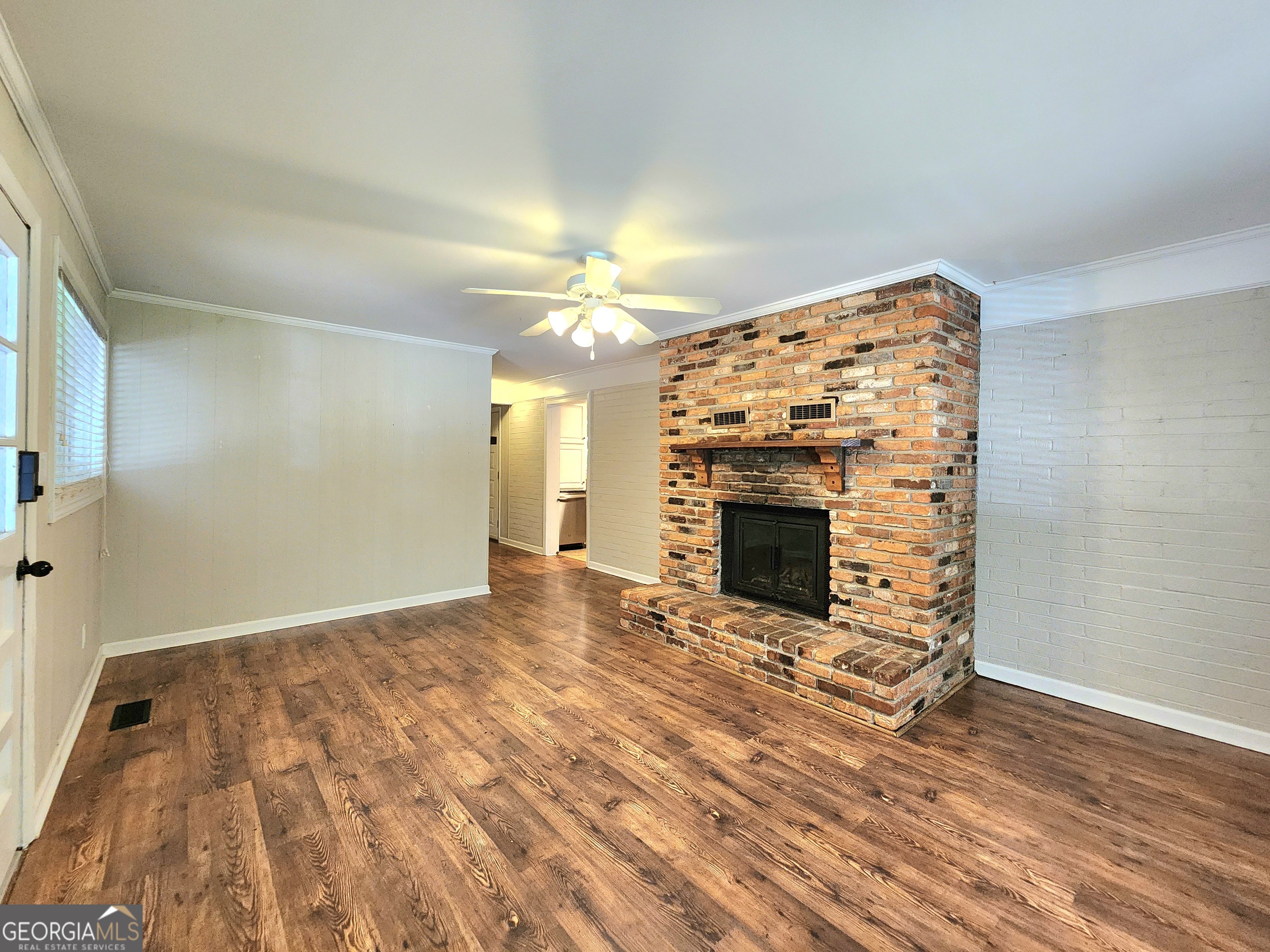 807 Wera Place Macon, GA 31210 - Photo 29 of 46 a view of a livingroom with wooden floor a fireplace and window