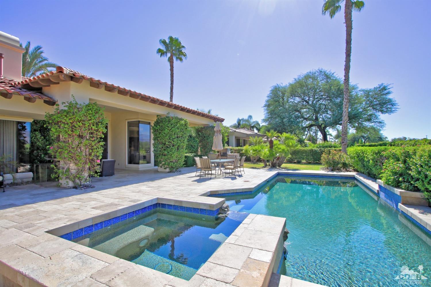 a view of a patio with swimming pool table and chairs