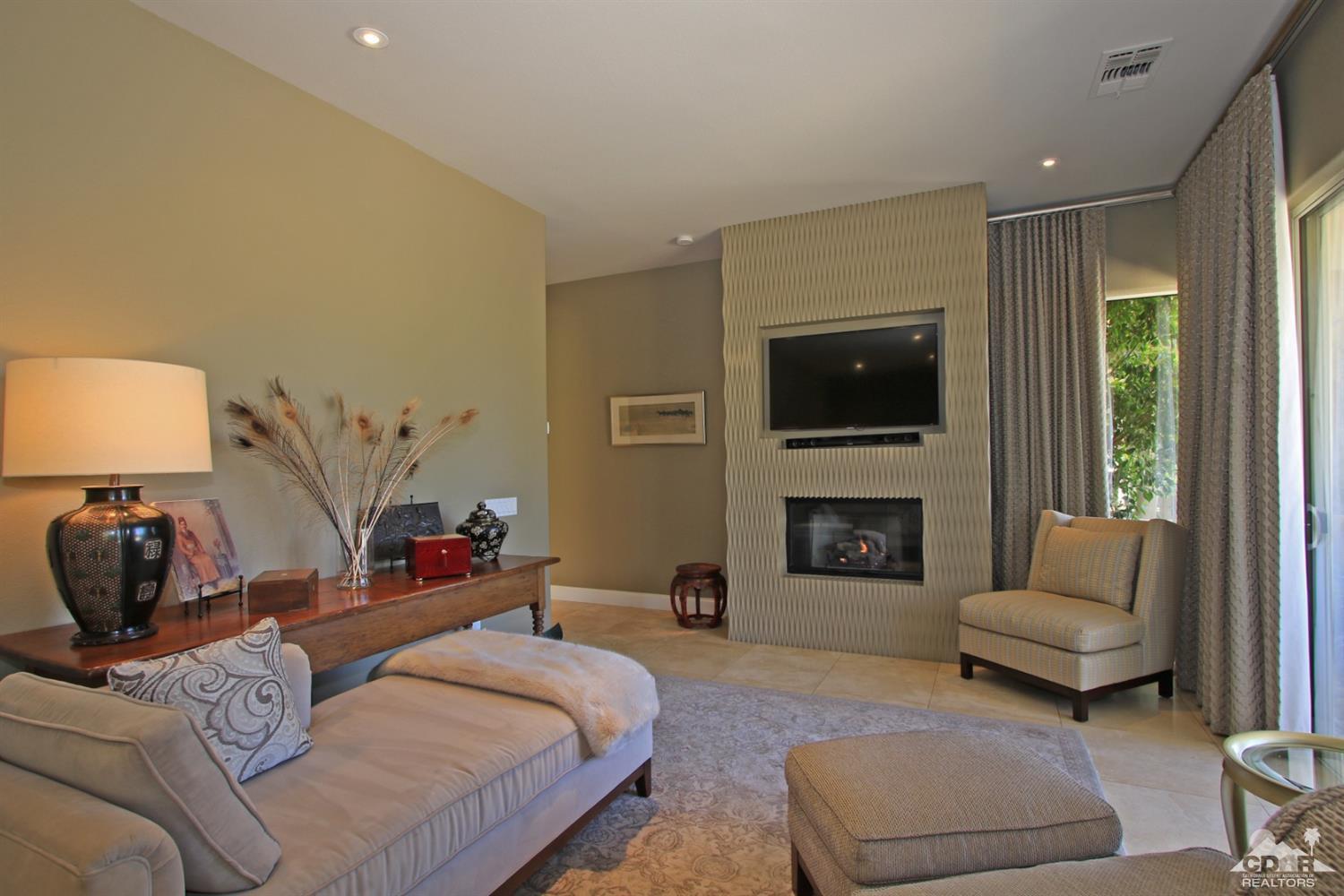 204 Loch Lomond Road Rancho Mirage, CA 92270 - Photo 22 of 45 a bedroom with furniture and a fireplace
