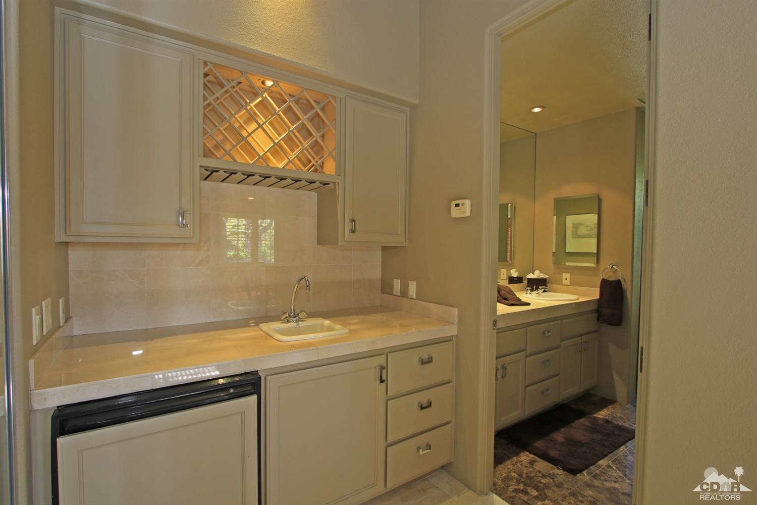 204 Loch Lomond Road Rancho Mirage, CA 92270 - Photo 30 of 45 a bathroom with a sink a vanity and mirror