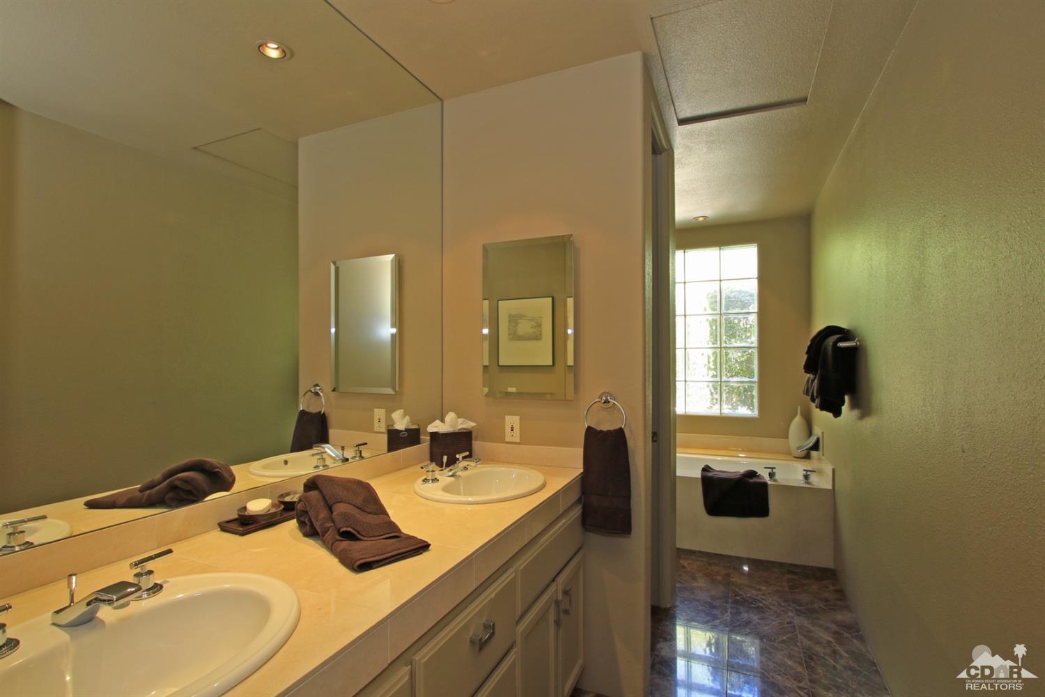 204 Loch Lomond Road Rancho Mirage, CA 92270 - Photo 31 of 45 a bathroom with a sink double vanity and shower