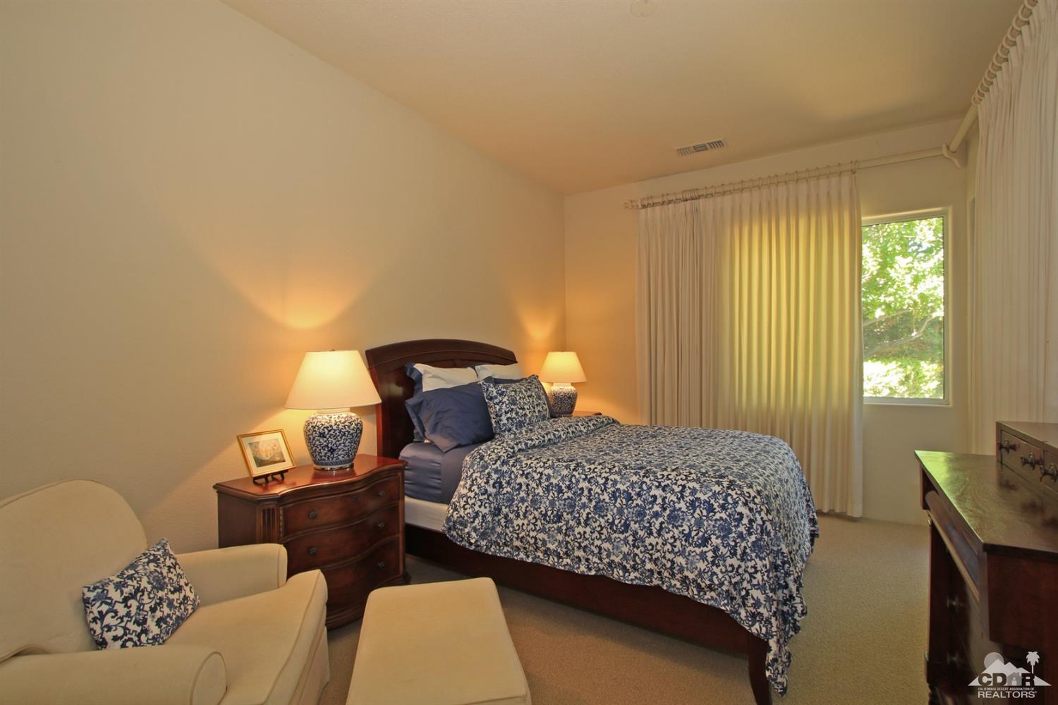 204 Loch Lomond Road Rancho Mirage, CA 92270 - Photo 37 of 45 a bedroom with a bed and wooden floor