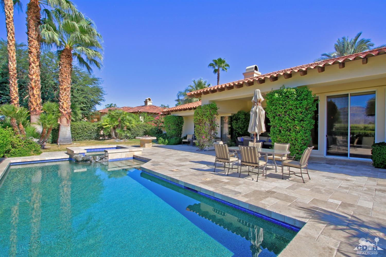 204 Loch Lomond Road Rancho Mirage, CA 92270 - Photo 41 of 45 a view of a patio with table and chairs potted plants and palm tree