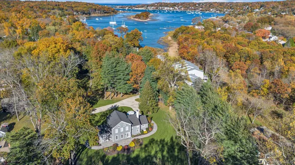 a front view of house with yard and trees