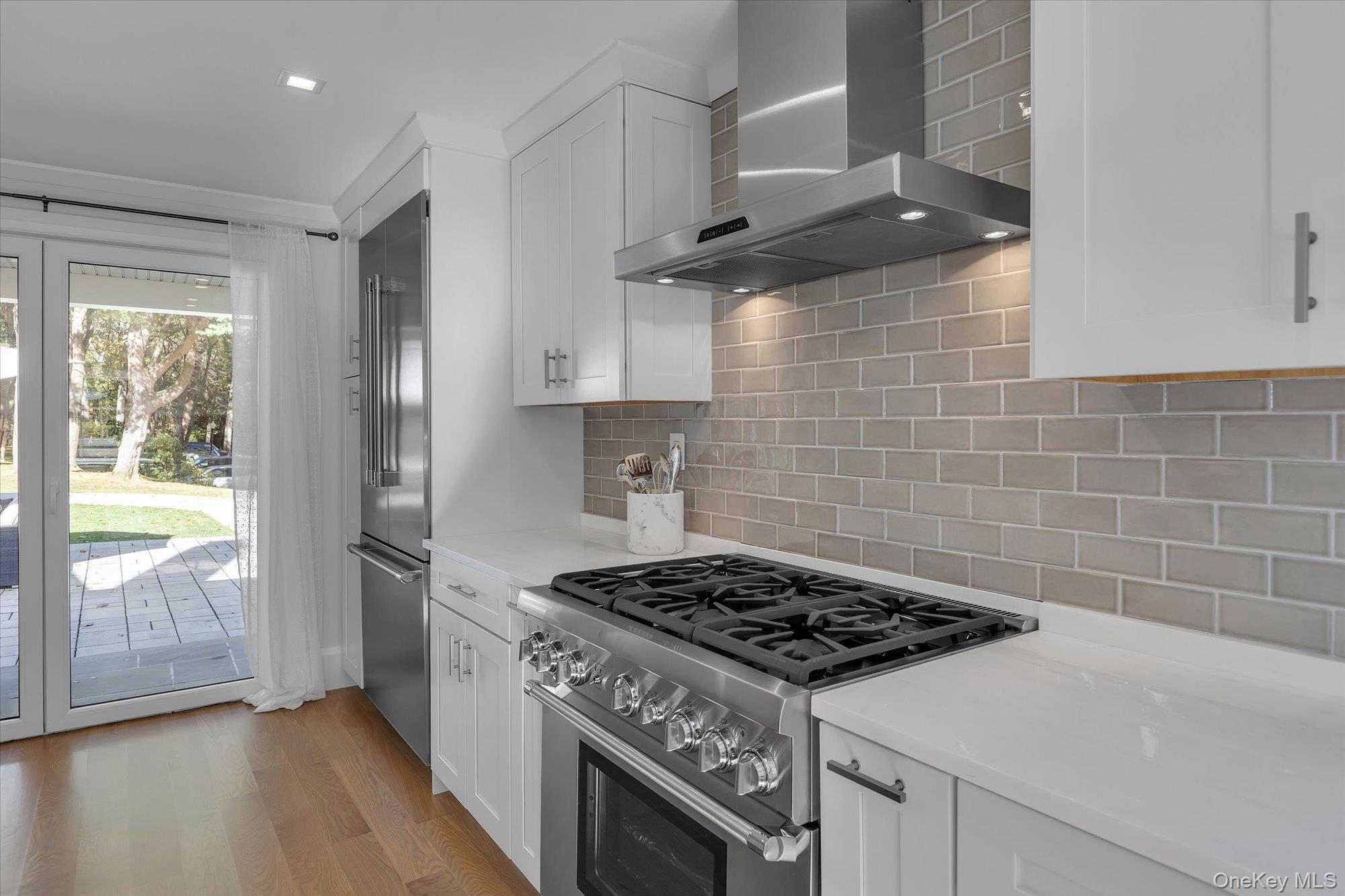 22 Fort Salonga Road Centerport, NY 11721 - Photo 14 of 42 a kitchen with granite countertop a stove and a wooden floor