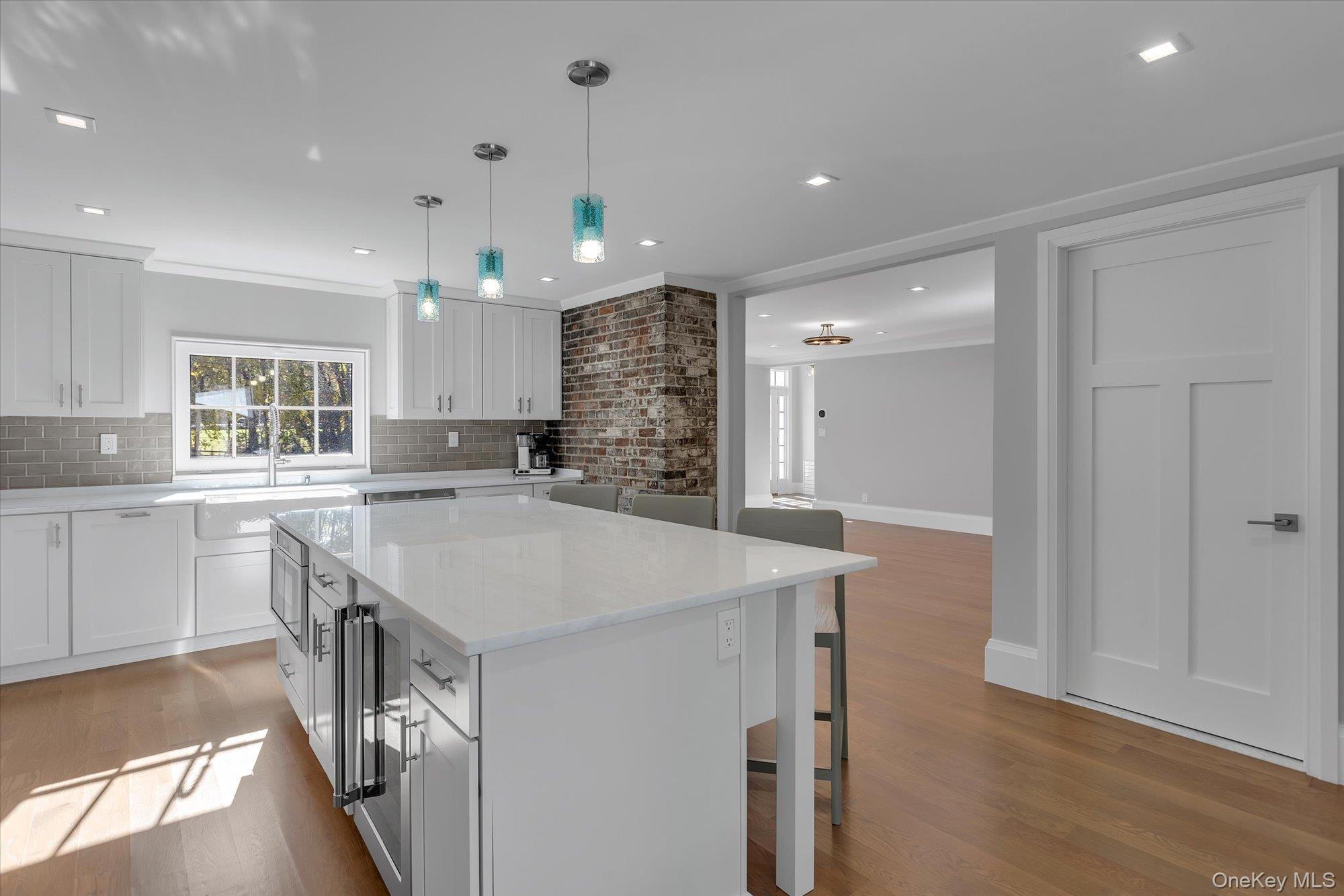 22 Fort Salonga Road Centerport, NY 11721 - Photo 15 of 42 Kitchen with center island, a breakfast bar, marble counters, a kitchen island, and pantry