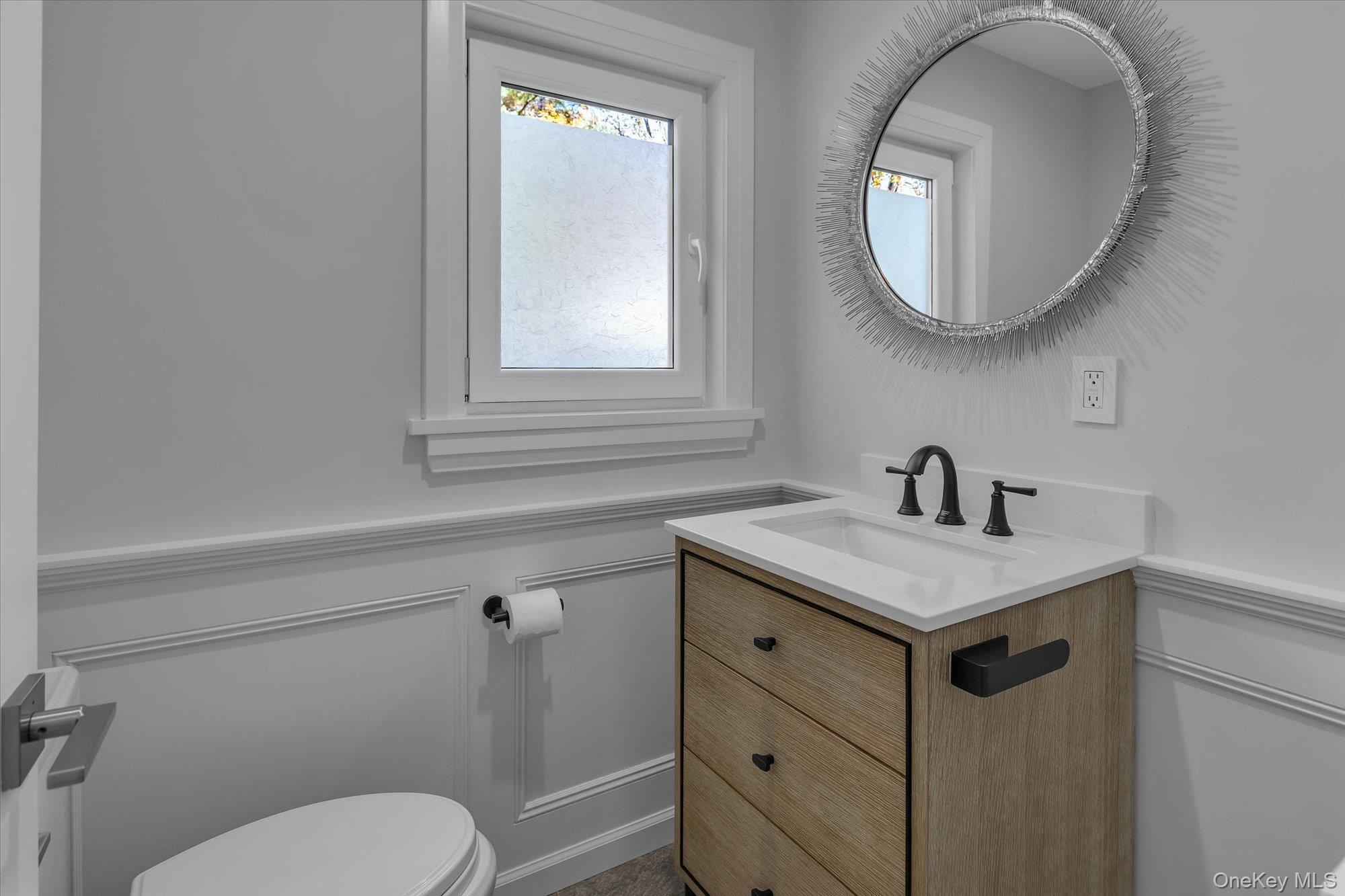 22 Fort Salonga Road Centerport, NY 11721 - Photo 20 of 42 a bathroom with a toilet sink vanity and mirror