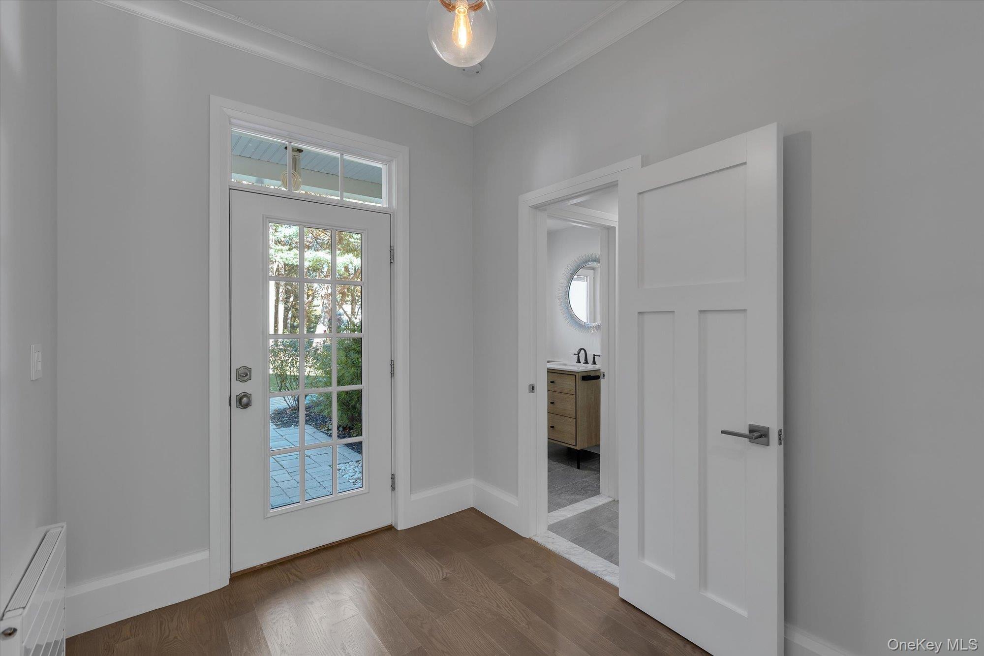 22 Fort Salonga Road Centerport, NY 11721 - Photo 21 of 42 Back entryway with ornamental molding, wood finished floors, and mudroom