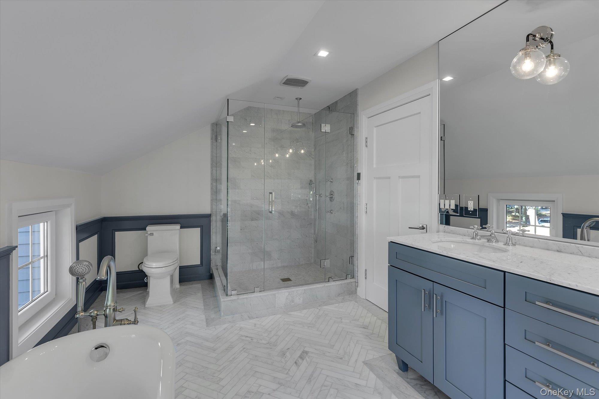22 Fort Salonga Road Centerport, NY 11721 - Photo 25 of 42 Bathroom with vaulted ceiling, plenty of natural light, vanity, a soaking tub, and a shower stall