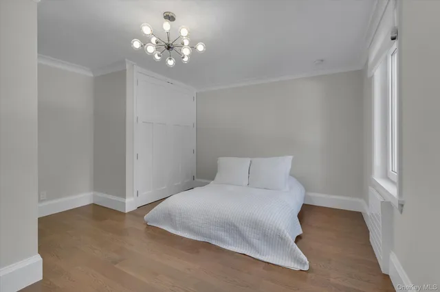 a front view of a house with a yard and tree